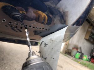 drilling holes in broken bumper